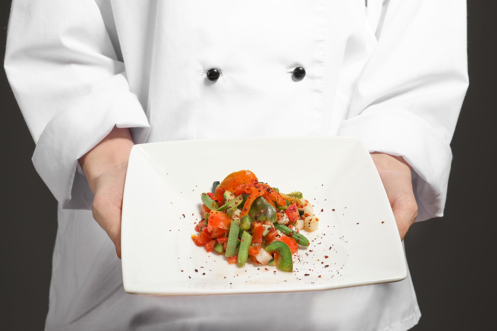Chef hands garnishing a dish